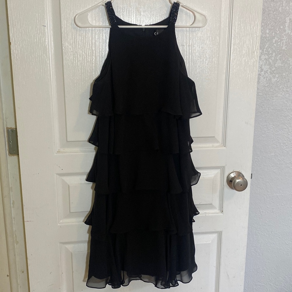 Beautiful sleeveless black dress with flowy ruffles